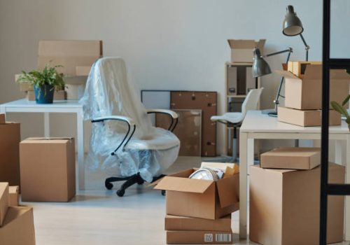 Horizontal image of big light office with new furniture and unpacked cardboard boxes